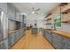 A beautifully designed kitchen featuring grey cabinets, hardwood floors, and stainless steel appliances at 2230 Ewing Chapel Rd, Dacula, GA 30019