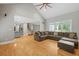 Spacious living room features an open floor plan with hardwood flooring, couch, and lots of natural light at 2230 Ewing Chapel Rd, Dacula, GA 30019