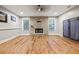 Spacious living room with a stone fireplace, wood floors, recessed lighting and access to the outdoor patio at 2230 Ewing Chapel Rd, Dacula, GA 30019