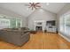 Bright living room boasts vaulted ceilings, a fireplace, hardwood floors, and large windows for natural light at 2230 Ewing Chapel Rd, Dacula, GA 30019