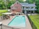 Backyard pool with poolside patio, lush grass, and patio with built-in grilling area at 2230 Ewing Chapel Rd, Dacula, GA 30019