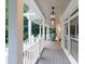 Spacious covered porch with rocking chair, wooden floors and white trim, great for relaxation at 2230 Ewing Chapel Rd, Dacula, GA 30019