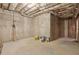 Unfinished basement with concrete walls and exposed ceiling, providing ample storage space at 315 Glengarry Chase, Covington, GA 30014