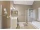 Relaxing bathroom boasts a soaking tub, walk-in shower, and white vanity with double sinks at 315 Glengarry Chase, Covington, GA 30014