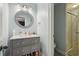 Bathroom with a decorated mirror, marble countertop, and tiled shower at 315 Glengarry Chase, Covington, GA 30014