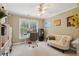 Bright bedroom featuring a ceiling fan, a window overlooking the yard, and charming decorative accents at 315 Glengarry Chase, Covington, GA 30014