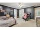 Spacious bedroom with black walls, a ceiling fan, and a closet at 315 Glengarry Chase, Covington, GA 30014