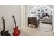 Bonus room with a futon, chair, and guitars along the wall at 315 Glengarry Chase, Covington, GA 30014