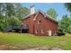 Stately two-story red brick home with a backyard, deck, and well-maintained lawn at 315 Glengarry Chase, Covington, GA 30014