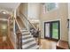 Grand foyer with staircase, hardwood floors, and elegant double doors at 315 Glengarry Chase, Covington, GA 30014