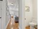 Inviting hallway with hardwood floors offers a view into the living room and a glimpse of the staircase at 315 Glengarry Chase, Covington, GA 30014