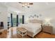 Spacious main bedroom boasts hardwood floors, bay windows, elegant decor and a seating area at 315 Glengarry Chase, Covington, GA 30014