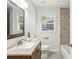 Bathroom featuring granite countertop, ceramic tiling, and ample sunlight at 3301 Irish Ln, Decatur, GA 30032