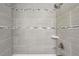 Updated bathroom shower with gray textured tile and modern fixtures at 3301 Irish Ln, Decatur, GA 30032