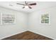 Bright bedroom featuring hardwood floors, ceiling fan, and large windows at 3301 Irish Ln, Decatur, GA 30032