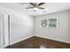 Bright bedroom featuring hardwood floors, ceiling fan, and large window at 3301 Irish Ln, Decatur, GA 30032