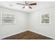Bright bedroom with beautiful wood floors, two windows with natural light, and a ceiling fan at 3301 Irish Ln, Decatur, GA 30032