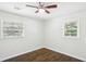 Bright bedroom featuring hardwood floors, ceiling fan, and two large windows at 3301 Irish Ln, Decatur, GA 30032