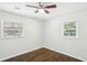 Sunny bedroom with beautiful wood floors, two windows with natural light, and a ceiling fan at 3301 Irish Ln, Decatur, GA 30032