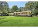 Well-maintained ranch home with brick exterior, lush lawn, and mature trees at 3301 Irish Ln, Decatur, GA 30032