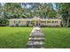 Charming brick home with a well-manicured lawn and inviting walkway leading to the front door at 3301 Irish Ln, Decatur, GA 30032