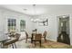 Bright breakfast nook features a modern chandelier, glass table, and access to the outdoors at 3301 Irish Ln, Decatur, GA 30032