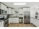 Updated kitchen features granite countertops, stainless steel appliances, and tiled backsplash at 3301 Irish Ln, Decatur, GA 30032
