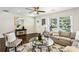 Bright living room featuring hardwood floors, a ceiling fan, and a comfortable seating area at 3301 Irish Ln, Decatur, GA 30032