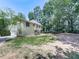 Backyard view of multi-story home with well-maintained yard and mature trees at 4601 Ethel Springs Sw Trl, Mableton, GA 30126
