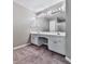 Bathroom featuring double vanity, large mirror, and shower in neutral color palette at 4601 Ethel Springs Sw Trl, Mableton, GA 30126