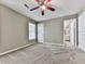 Bedroom featuring neutral walls, carpet, ceiling fan, and ensuite bath and closet access at 4601 Ethel Springs Sw Trl, Mableton, GA 30126