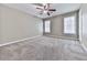 Bedroom featuring neutral walls, carpet, ceiling fan, and two large windows at 4601 Ethel Springs Sw Trl, Mableton, GA 30126
