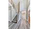 Grand foyer with high ceilings, staircase, wood-look flooring and chandelier in adjacent room at 4601 Ethel Springs Sw Trl, Mableton, GA 30126