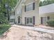 Charming home exterior featuring well-maintained landscaping, a red front door and neutral stucco at 4601 Ethel Springs Sw Trl, Mableton, GA 30126