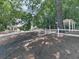 View of front yard with split rail fence, mature trees, and home in the background at 4601 Ethel Springs Sw Trl, Mableton, GA 30126