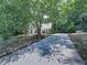 Spacious front yard with mature tree, long driveway and partial view of home at 4601 Ethel Springs Sw Trl, Mableton, GA 30126