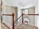 Second-floor landing with railing, modern chandelier and lots of natural light at 4601 Ethel Springs Sw Trl, Mableton, GA 30126