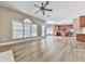 Open-concept living room with lots of windows, wood-look floors and a view to the kitchen at 4601 Ethel Springs Sw Trl, Mableton, GA 30126