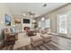 Cozy living room with fireplace, ceiling fan, and neutral decor with plenty of natural light at 4601 Ethel Springs Sw Trl, Mableton, GA 30126