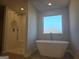 Bright bathroom with free standing tub and glass enclosed shower at 1672 Fuma Leaf Way, Mcdonough, GA 30252