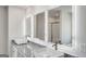 Bright bathroom featuring double vanities, modern faucets, sleek counter tops, and illuminated mirrors at 1672 Fuma Leaf Way, Mcdonough, GA 30252