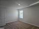 Bedroom with carpet flooring, window, and double door closet at 1672 Fuma Leaf Way, Mcdonough, GA 30252