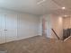 A carpeted bedroom with an access door and a walk through to another room at 1672 Fuma Leaf Way, Mcdonough, GA 30252