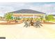 Community space featuring a covered patio, a playground, lounge chairs, and a fire pit at 1672 Fuma Leaf Way, Mcdonough, GA 30252