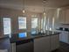 Spacious kitchen featuring modern stainless steel appliances, gray cabinetry, and stylish pendant lighting at 1672 Fuma Leaf Way, Mcdonough, GA 30252