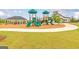 Community playground with green slides, a gazebo with lounge chairs, and green grass at 1672 Fuma Leaf Way, Mcdonough, GA 30252