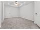 Spacious carpeted bedroom with neutral decor and ceiling fan at 2348 Bigwood Trl, Atlanta, GA 30349