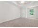 Carpeted bedroom featuring neutral walls and natural light at 2348 Bigwood Trl, Atlanta, GA 30349