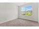 Bright and neutral carpeted bedroom with a large window and fresh paint throughout at 2348 Bigwood Trl, Atlanta, GA 30349