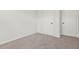 Neutral carpeted bedroom with two white paneled doors and fresh paint throughout at 2348 Bigwood Trl, Atlanta, GA 30349